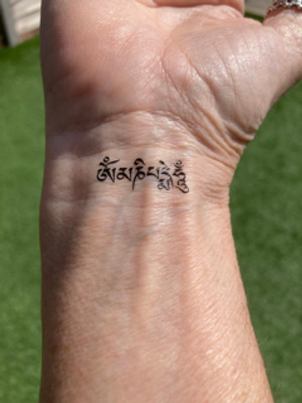 Tattoo calligraphy in sanskrit om mani padme hum  meaning on the jewel  shining in the lotus buddhist mantra  CanStock