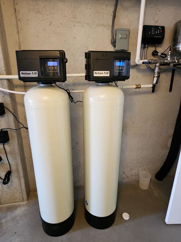 Two Fleck 2510AIO iron filters installed in basement next to water heater