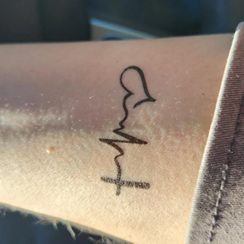 Minimalist Faith Hope Love symbol tattoo done on the