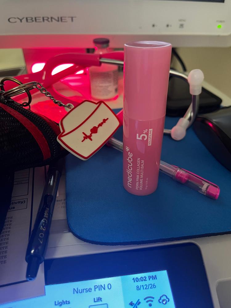 Pink collagen balm on a desk