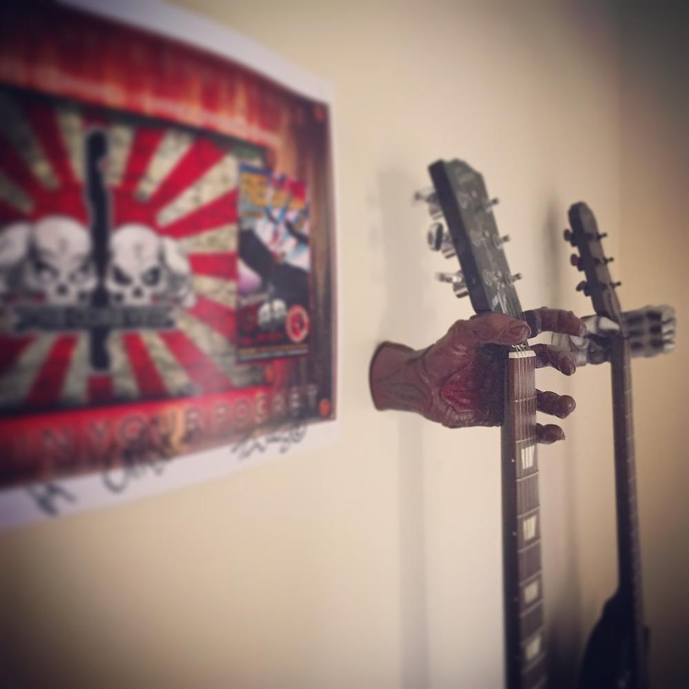 Skeleton hand deals guitar hanger